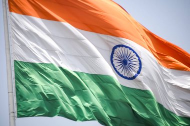 India flag flying high at Connaught Place with pride in blue sky, India flag fluttering, Indian Flag on Independence Day and Republic Day of India, tilt up shot, Waving Indian flag, Har Ghar Tiranga