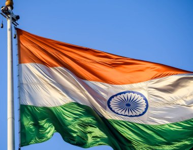 India flag flying high at Connaught Place with pride in blue sky, India flag fluttering, Indian Flag on Independence Day and Republic Day of India, tilt up shot, Waving Indian flag, Har Ghar Tiranga