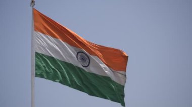 India flag flying high at Connaught Place with pride in blue sky, India flag fluttering, Indian Flag on Independence Day and Republic Day of India, tilt up shot, Waving Indian flag, Har Ghar Tiranga