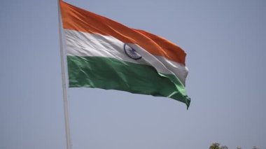 India flag flying high at Connaught Place with pride in blue sky, India flag fluttering, Indian Flag on Independence Day and Republic Day of India, tilt up shot, Waving Indian flag, Har Ghar Tiranga
