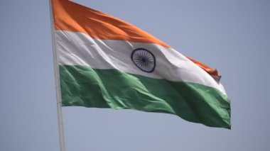 India flag flying high at Connaught Place with pride in blue sky, India flag fluttering, Indian Flag on Independence Day and Republic Day of India, tilt up shot, Waving Indian flag, Har Ghar Tiranga