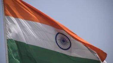 India flag flying high at Connaught Place with pride in blue sky, India flag fluttering, Indian Flag on Independence Day and Republic Day of India, tilt up shot, Waving Indian flag, Har Ghar Tiranga