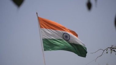 India flag flying high at Connaught Place with pride in blue sky, India flag fluttering, Indian Flag on Independence Day and Republic Day of India, tilt up shot, Waving Indian flag, Har Ghar Tiranga