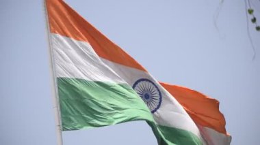 India flag flying high at Connaught Place with pride in blue sky, India flag fluttering, Indian Flag on Independence Day and Republic Day of India, tilt up shot, Waving Indian flag, Har Ghar Tiranga