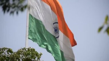 India flag flying high at Connaught Place with pride in blue sky, India flag fluttering, Indian Flag on Independence Day and Republic Day of India, tilt up shot, Waving Indian flag, Har Ghar Tiranga
