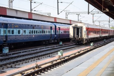 Delhi, India, June 09 2024 - Indian railway express train at departure from Anand Vihar railway station during morning time, Colourful Express train at Delhi railway station clipart