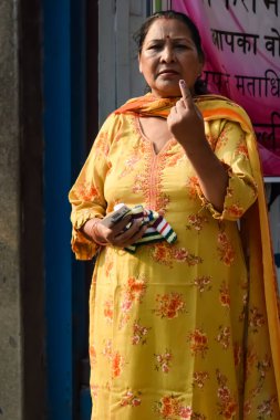 New Delhi, India - May 25 2024 - Unidentified people showing their ink-marked fingers after casting votes in front of polling booth of east Delhi area for general Lok Sabha Elections 2024 clipart