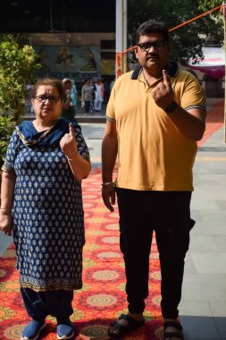 New Delhi, India - May 25 2024 - Unidentified people showing their ink-marked fingers after casting votes in front of polling booth of east Delhi area for general Lok Sabha Elections 2024 clipart