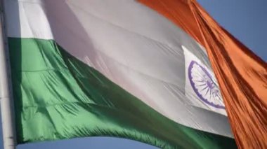 India flag flying high at Connaught Place with pride in blue sky, India flag fluttering, Indian Flag on Independence Day and Republic Day of India, tilt up shot, Waving Indian flag, Har Ghar Tiranga