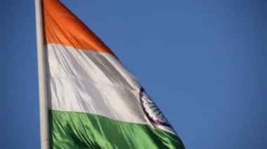 India flag flying high at Connaught Place with pride in blue sky, India flag fluttering, Indian Flag on Independence Day and Republic Day of India, tilt up shot, Waving Indian flag, Har Ghar Tiranga