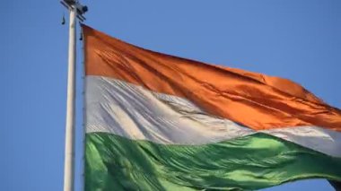 India flag flying high at Connaught Place with pride in blue sky, India flag fluttering, Indian Flag on Independence Day and Republic Day of India, tilt up shot, Waving Indian flag, Har Ghar Tiranga