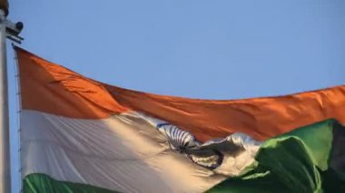 India flag flying high at Connaught Place with pride in blue sky, India flag fluttering, Indian Flag on Independence Day and Republic Day of India, tilt up shot, Waving Indian flag, Har Ghar Tiranga