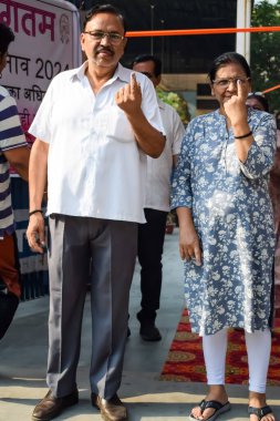 New Delhi, India - May 25 2024 - Unidentified people showing their ink-marked fingers after casting votes in front of polling booth of east Delhi area for general Lok Sabha Elections 2024 clipart