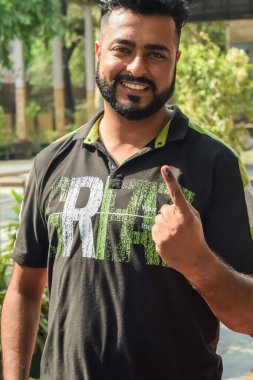 New Delhi, India - May 25 2024 - Unidentified people showing their ink-marked fingers after casting votes in front of polling booth of east Delhi area for general Lok Sabha Elections 2024 clipart