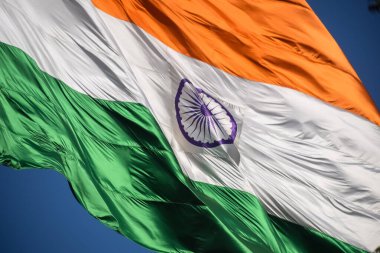 India flag flying high at Connaught Place with pride in blue sky, India flag fluttering, Indian Flag on Independence Day and Republic Day of India, tilt up shot, Waving Indian flag, Har Ghar Tiranga