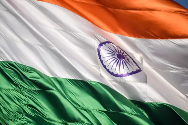 stock image India flag flying high at Connaught Place with pride in blue sky, India flag fluttering, Indian Flag on Independence Day and Republic Day of India, tilt up shot, Waving Indian flag, Har Ghar Tiranga