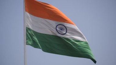 India flag flying high at Connaught Place with pride in blue sky, India flag fluttering, Indian Flag on Independence Day and Republic Day of India, tilt up shot, Waving Indian flag, Har Ghar Tiranga