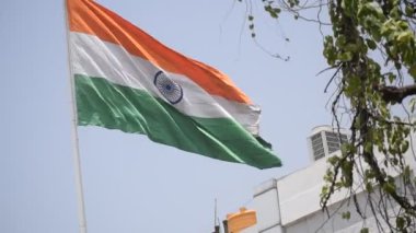 India flag flying high at Connaught Place with pride in blue sky, India flag fluttering, Indian Flag on Independence Day and Republic Day of India, tilt up shot, Waving Indian flag, Har Ghar Tiranga