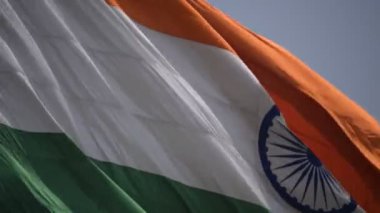 India flag flying high at Connaught Place with pride in blue sky, India flag fluttering, Indian Flag on Independence Day and Republic Day of India, tilt up shot, Waving Indian flag, Har Ghar Tiranga
