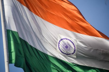 India flag flying high at Connaught Place with pride in blue sky, India flag fluttering, Indian Flag on Independence Day and Republic Day of India, tilt up shot, Waving Indian flag, Har Ghar Tiranga