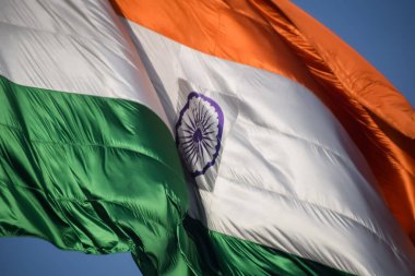 India flag flying high at Connaught Place with pride in blue sky, India flag fluttering, Indian Flag on Independence Day and Republic Day of India, tilt up shot, Waving Indian flag, Har Ghar Tiranga