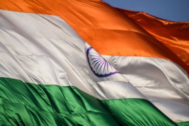 India flag flying high at Connaught Place with pride in blue sky, India flag fluttering, Indian Flag on Independence Day and Republic Day of India, tilt up shot, Waving Indian flag, Har Ghar Tiranga