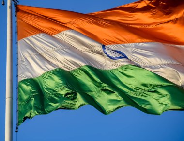 India flag flying high at Connaught Place with pride in blue sky, India flag fluttering, Indian Flag on Independence Day and Republic Day of India, tilt up shot, Waving Indian flag, Har Ghar Tiranga