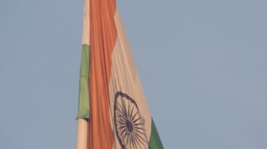 India flag flying high at Connaught Place with pride in blue sky, India flag fluttering, Indian Flag on Independence Day and Republic Day of India, tilt up shot, Waving Indian flag, Har Ghar Tiranga