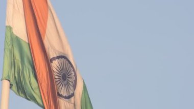 India flag flying high at Connaught Place with pride in blue sky, India flag fluttering, Indian Flag on Independence Day and Republic Day of India, tilt up shot, Waving Indian flag, Har Ghar Tiranga