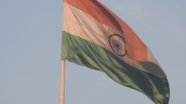 India flag flying high at Connaught Place with pride in blue sky, India flag fluttering, Indian Flag on Independence Day and Republic Day of India, tilt up shot, Waving Indian flag, Har Ghar Tiranga
