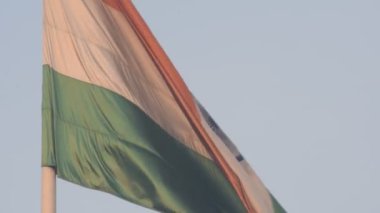 India flag flying high at Connaught Place with pride in blue sky, India flag fluttering, Indian Flag on Independence Day and Republic Day of India, tilt up shot, Waving Indian flag, Har Ghar Tiranga