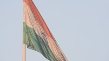 India flag flying high at Connaught Place with pride in blue sky, India flag fluttering, Indian Flag on Independence Day and Republic Day of India, tilt up shot, Waving Indian flag, Har Ghar Tiranga