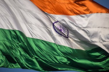 India flag flying high at Connaught Place with pride in blue sky, India flag fluttering, Indian Flag on Independence Day and Republic Day of India, tilt up shot, Waving Indian flag, Har Ghar Tiranga