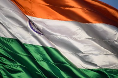India flag flying high at Connaught Place with pride in blue sky, India flag fluttering, Indian Flag on Independence Day and Republic Day of India, tilt up shot, Waving Indian flag, Har Ghar Tiranga