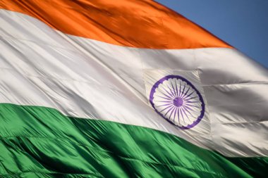 India flag flying high at Connaught Place with pride in blue sky, India flag fluttering, Indian Flag on Independence Day and Republic Day of India, tilt up shot, Waving Indian flag, Har Ghar Tiranga