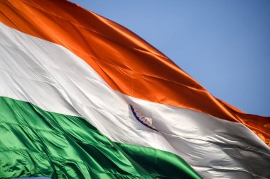 India flag flying high at Connaught Place with pride in blue sky, India flag fluttering, Indian Flag on Independence Day and Republic Day of India, tilt up shot, Waving Indian flag, Har Ghar Tiranga