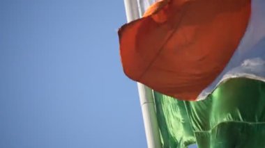 India flag flying high at Connaught Place with pride in blue sky, India flag fluttering, Indian Flag on Independence Day and Republic Day of India, tilt up shot, Waving Indian flag, Har Ghar Tiranga