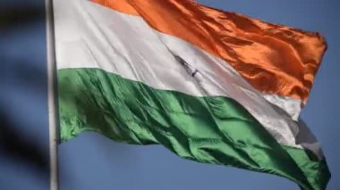 India flag flying high at Connaught Place with pride in blue sky, India flag fluttering, Indian Flag on Independence Day and Republic Day of India, tilt up shot, Waving Indian flag, Har Ghar Tiranga