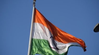 India flag flying high at Connaught Place with pride in blue sky, India flag fluttering, Indian Flag on Independence Day and Republic Day of India, tilt up shot, Waving Indian flag, Har Ghar Tiranga