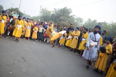 Delhi, India, August 15, 2024 - Sikhs display gatka and martial arts during annual Nagar Kirtan, Traditional, procession on account of birthday of Guru Nanak Dev ji, Nagar Kirtan in East Delhi area clipart