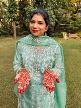 Beautiful woman dressed up as Indian tradition with henna mehndi design on her both hands to celebrate big festival of Karwa Chauth, Karwa Chauth celebrations by Indian woman for her husband clipart