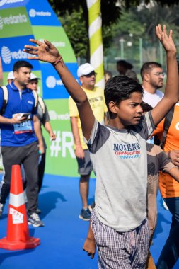 Yeni Delhi, Hindistan - 20 Ekim 2024 - Bitmek üzere olan maraton katılımcılarının bitiş çizgisini geçmek üzere olan Delhi Yarı Maratonu 2024