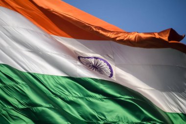 India flag flying high at Connaught Place with pride in blue sky, India flag fluttering, Indian Flag on Independence Day and Republic Day of India, tilt up shot, Waving Indian flag, Har Ghar Tiranga
