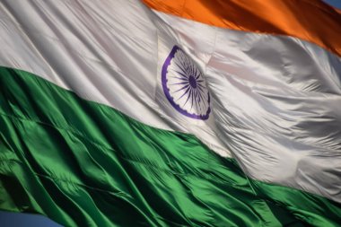 India flag flying high at Connaught Place with pride in blue sky, India flag fluttering, Indian Flag on Independence Day and Republic Day of India, tilt up shot, Waving Indian flag, Har Ghar Tiranga