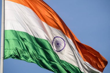 India flag flying high at Connaught Place with pride in blue sky, India flag fluttering, Indian Flag on Independence Day and Republic Day of India, tilt up shot, Waving Indian flag, Har Ghar Tiranga