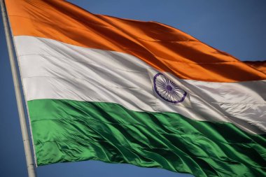 India flag flying high at Connaught Place with pride in blue sky, India flag fluttering, Indian Flag on Independence Day and Republic Day of India, tilt up shot, Waving Indian flag, Har Ghar Tiranga