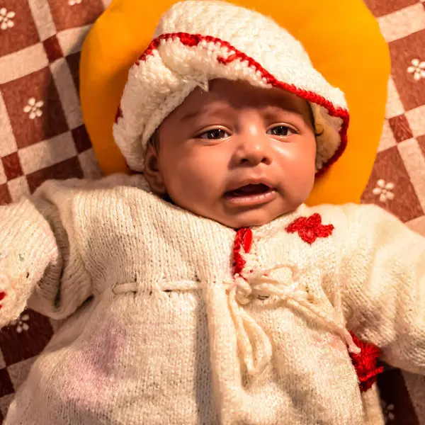 10 aylık sevimli küçük Hintli çocuk evde mutlu anların tadını çıkarıyor, tatlı küçük çocuk evde oynayan ve gülümseyen küçük bebekle eğleniyor.