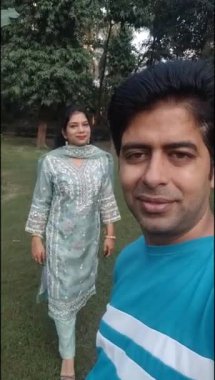 Hint geleneği gibi giyinmiş güzel bir Hint çifti. İki elinde de Henna Mehndi tasarımı var. Hintli kadının kocası için Karwa Chauth bayramını kutluyorlar.