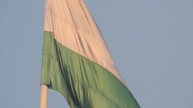 India flag flying high at Connaught Place with pride in blue sky, India flag fluttering, Indian Flag on Independence Day and Republic Day of India, tilt up shot, Waving Indian flag, Har Ghar Tiranga