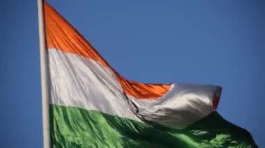 India flag flying high at Connaught Place with pride in blue sky, India flag fluttering, Indian Flag on Independence Day and Republic Day of India, tilt up shot, Waving Indian flag, Har Ghar Tiranga